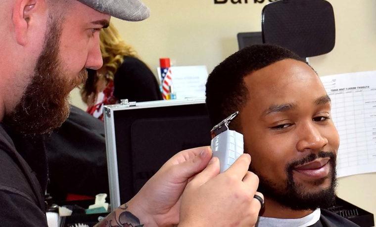 man cutting another's hair