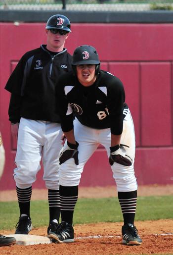 Jordan Alves coaches Patrick McMeel on first base.  (Campbellsville University Photo by Richard RoBards)