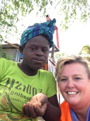 Angie Atwood, assistant professor of nursing  at Campbellsville University, makes a friend in  Haiti.